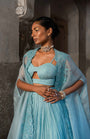 A Pwder Blue Lehenga With Maching Blouse And Cape