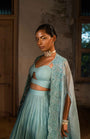 A Pwder Blue Lehenga With Maching Blouse And Cape
