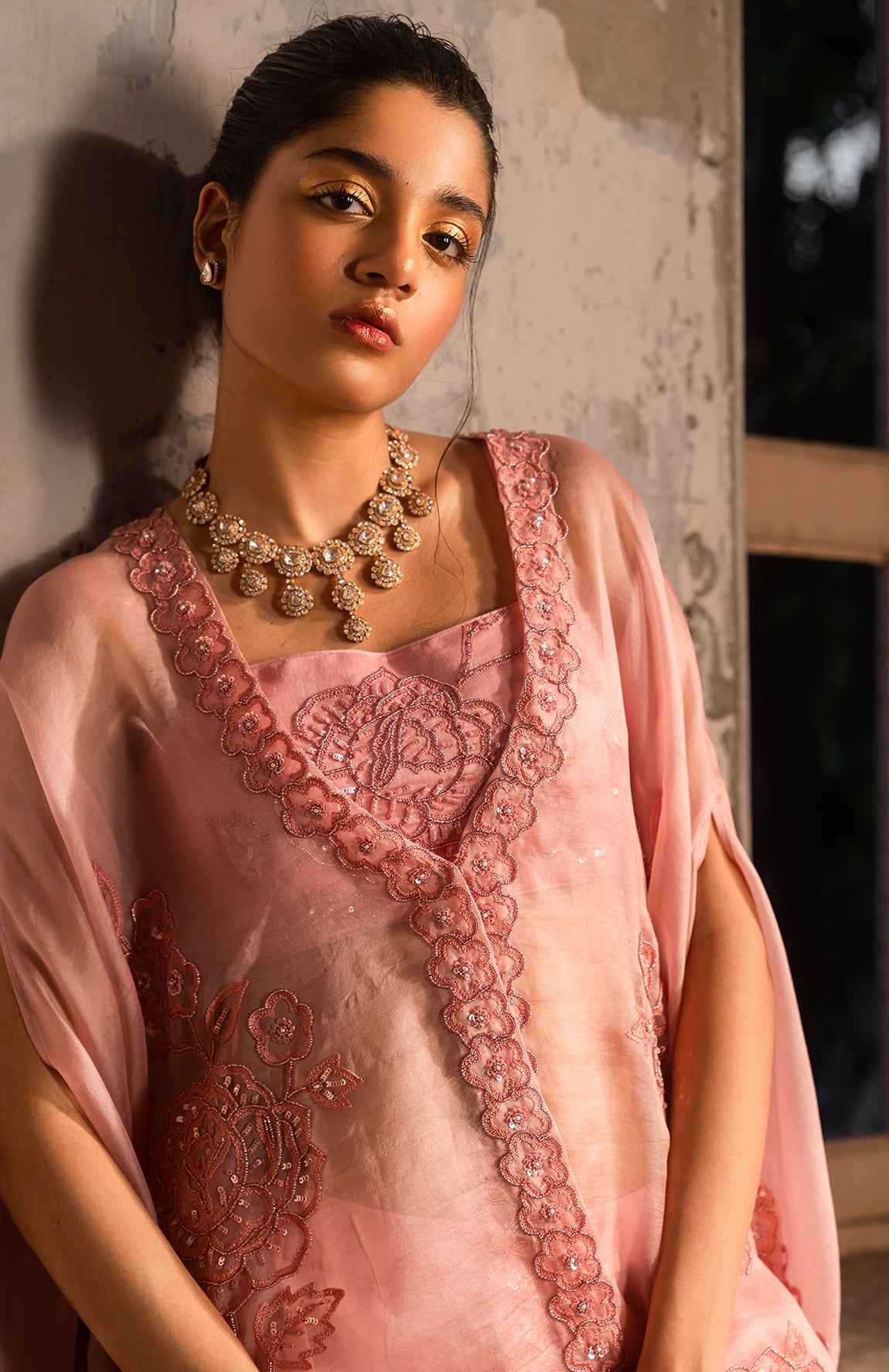 A Baby Pink Jacket Set Paired With Bustier And Skirt