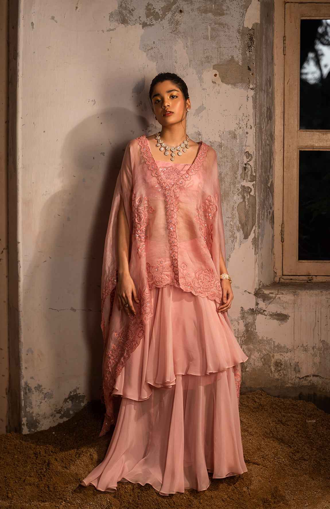 A Baby Pink Jacket Set Paired With Bustier And Skirt