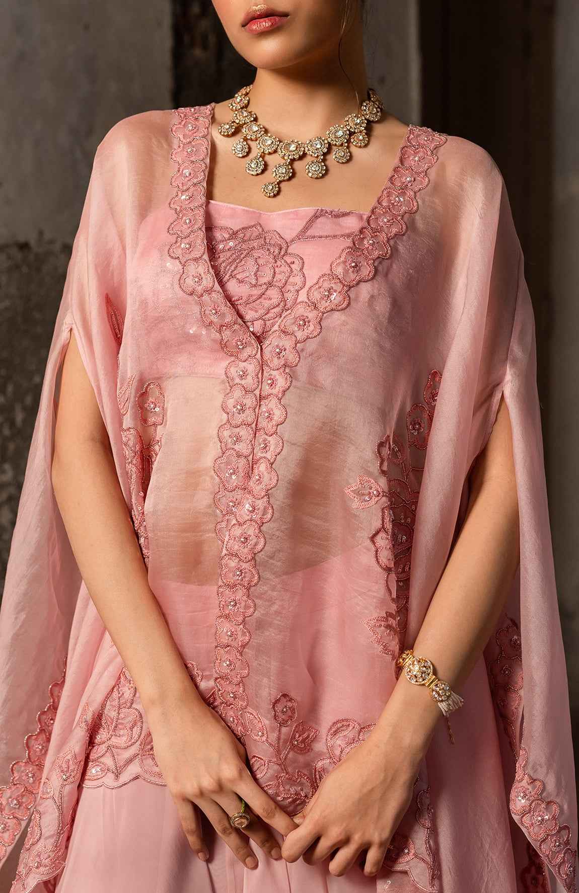 A Baby Pink Jacket Set Paired With Bustier And Skirt