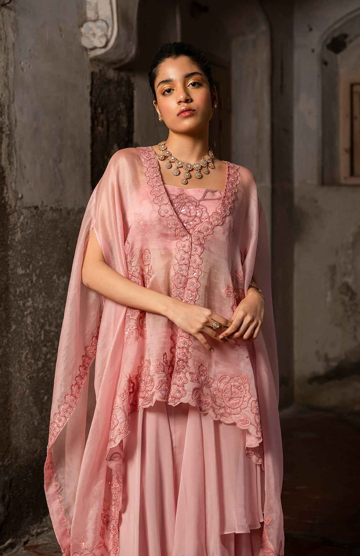 A Baby Pink Jacket Set Paired With Bustier And Skirt