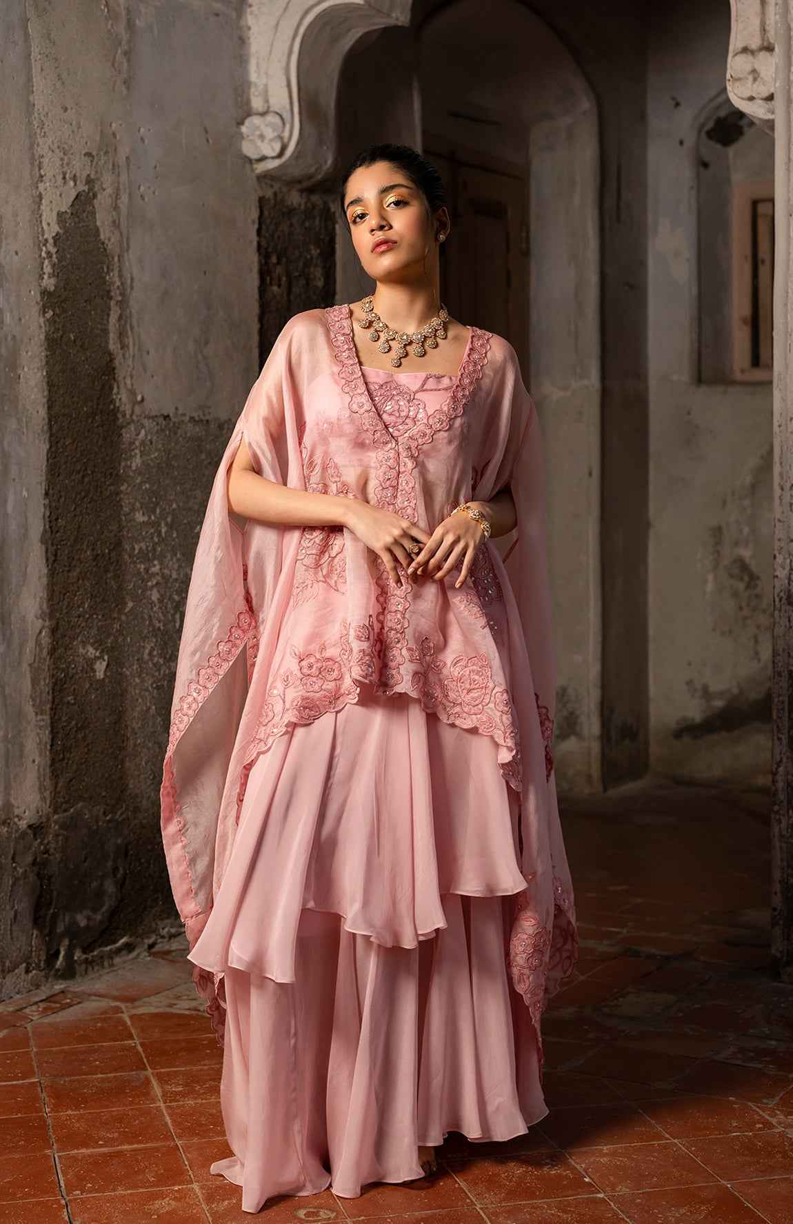 A Baby Pink Jacket Set Paired With Bustier And Skirt