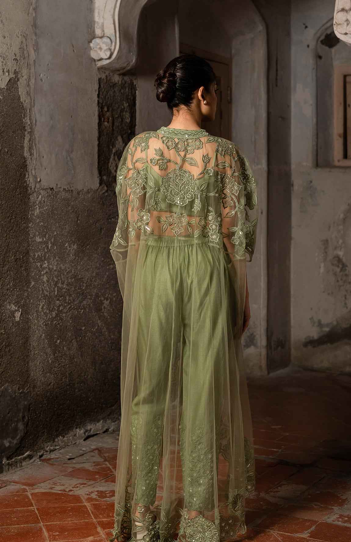 A Long Cape Paired With Bustier And Pants