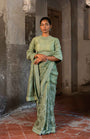 A Pista Green Embroidered Saree With High Neck Blouse