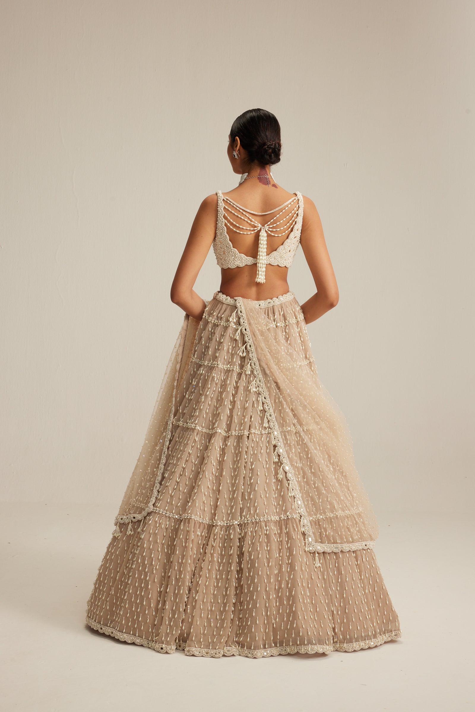 Light Beige Pearl Drop Multi Tier Lehenga Set.
