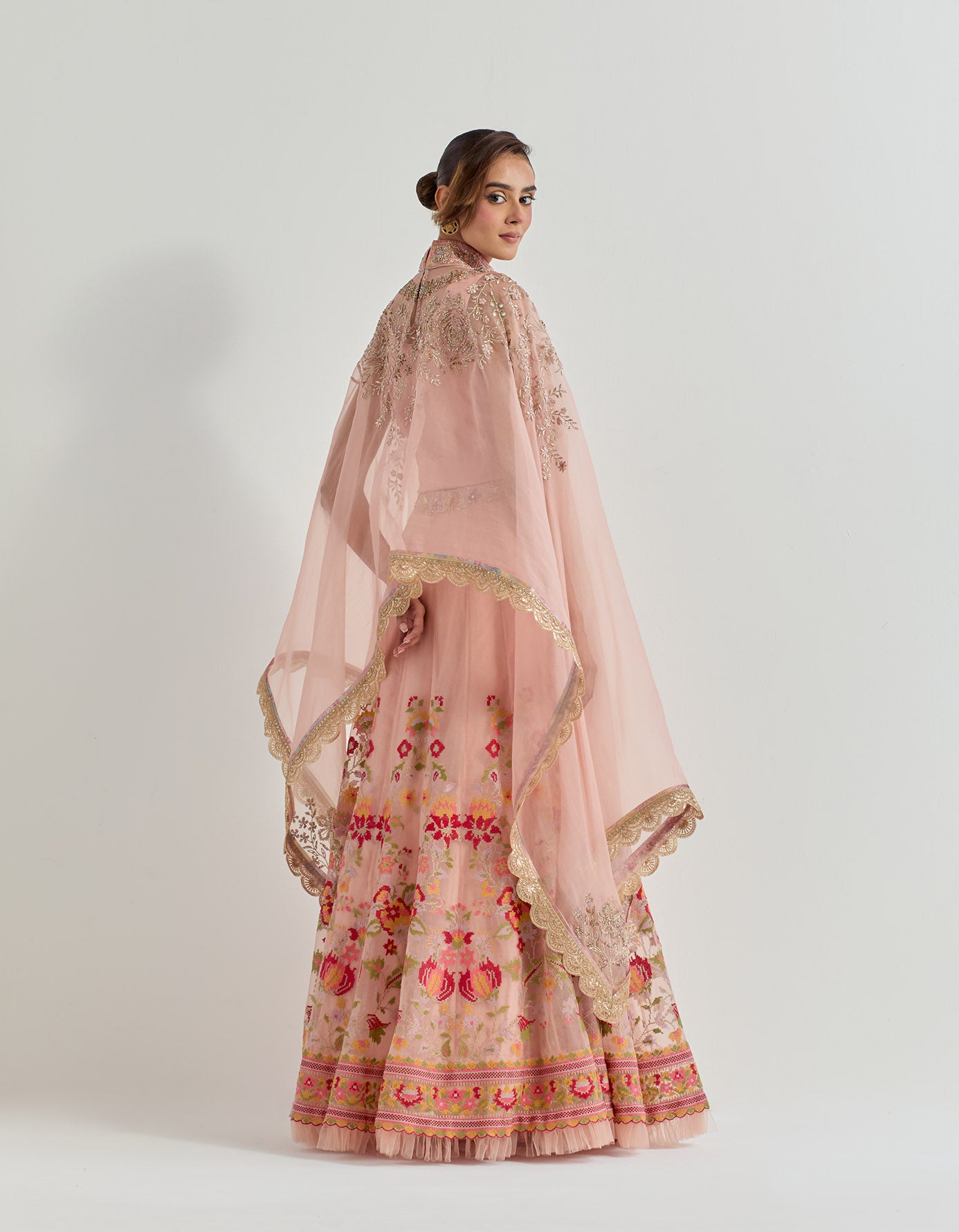 Hand emebllished dupatta cape paired with cross stitch embroidered skirt with frill detail at the hem