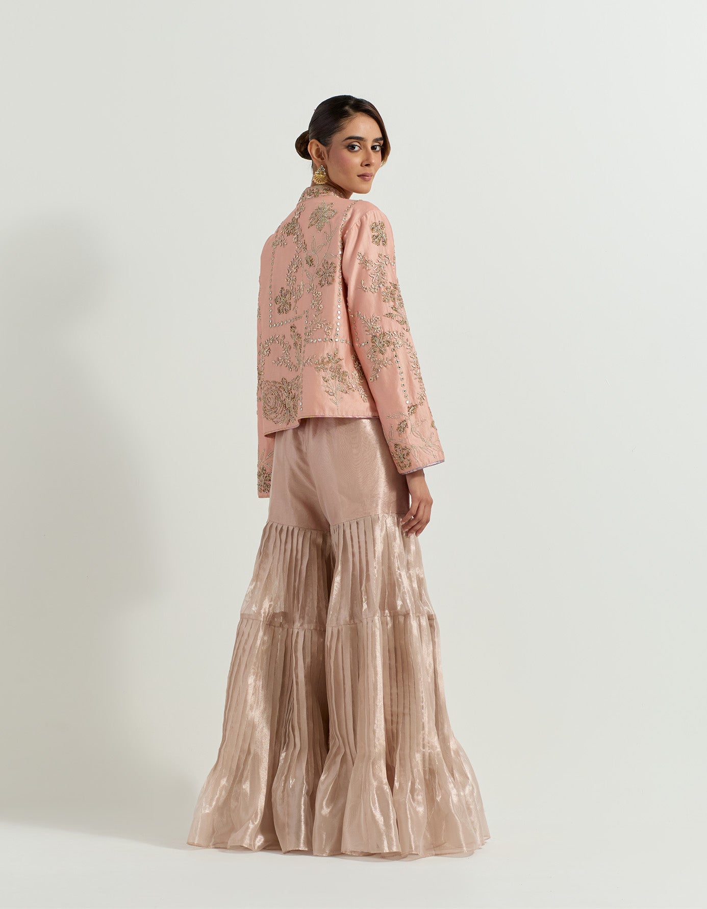 Chanderi silk hand embellished jacket paired with hand embroidered bustier and tissue pleated gharara