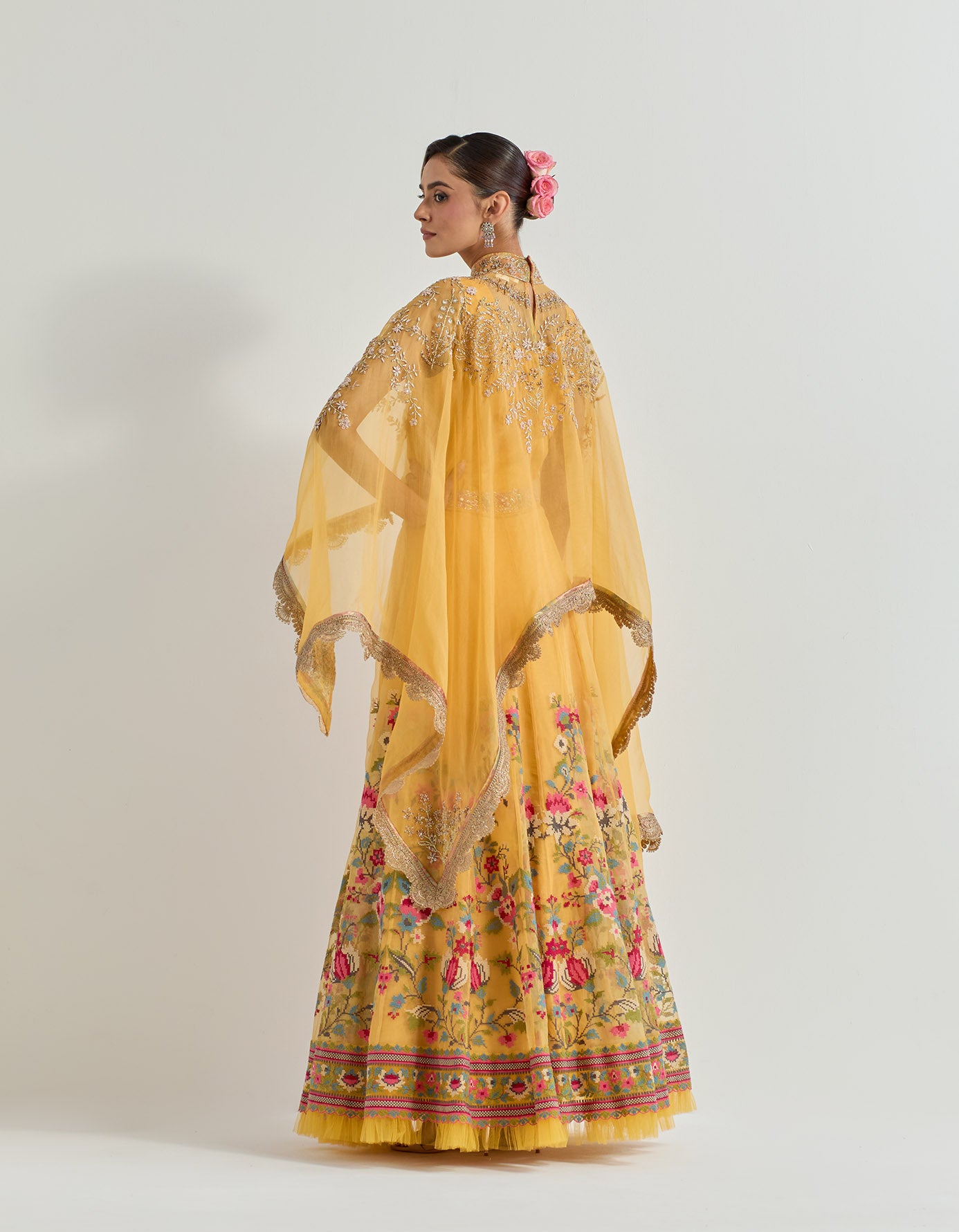 Hand emebllished dupatta cape paired with cross stitch embroidered skirt with frill detail at the hem