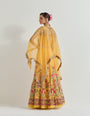 Hand emebllished dupatta cape paired with cross stitch embroidered skirt with frill detail at the hem