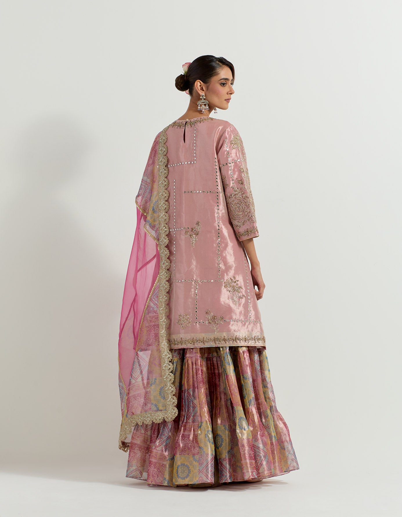 Fuchsia tissue hand embellished long tunic paired with tissue bandhini printed  pleated sharara and organza and tissue patch work dupatta