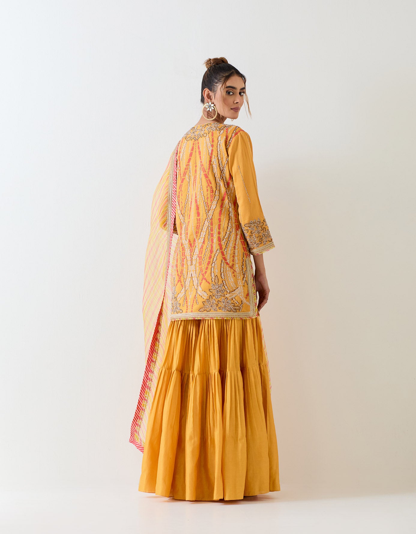 Mustard yellow sharara set in exquisite hand embroidery and tie dye dupatta