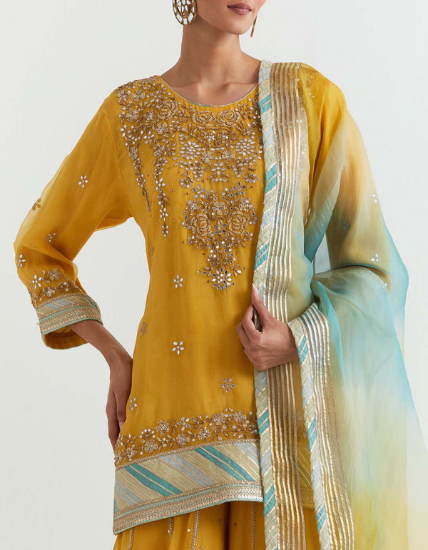 Yellow organza hand embroidered kurti paired with muqaish georgette sharara and organza shaded dupatta