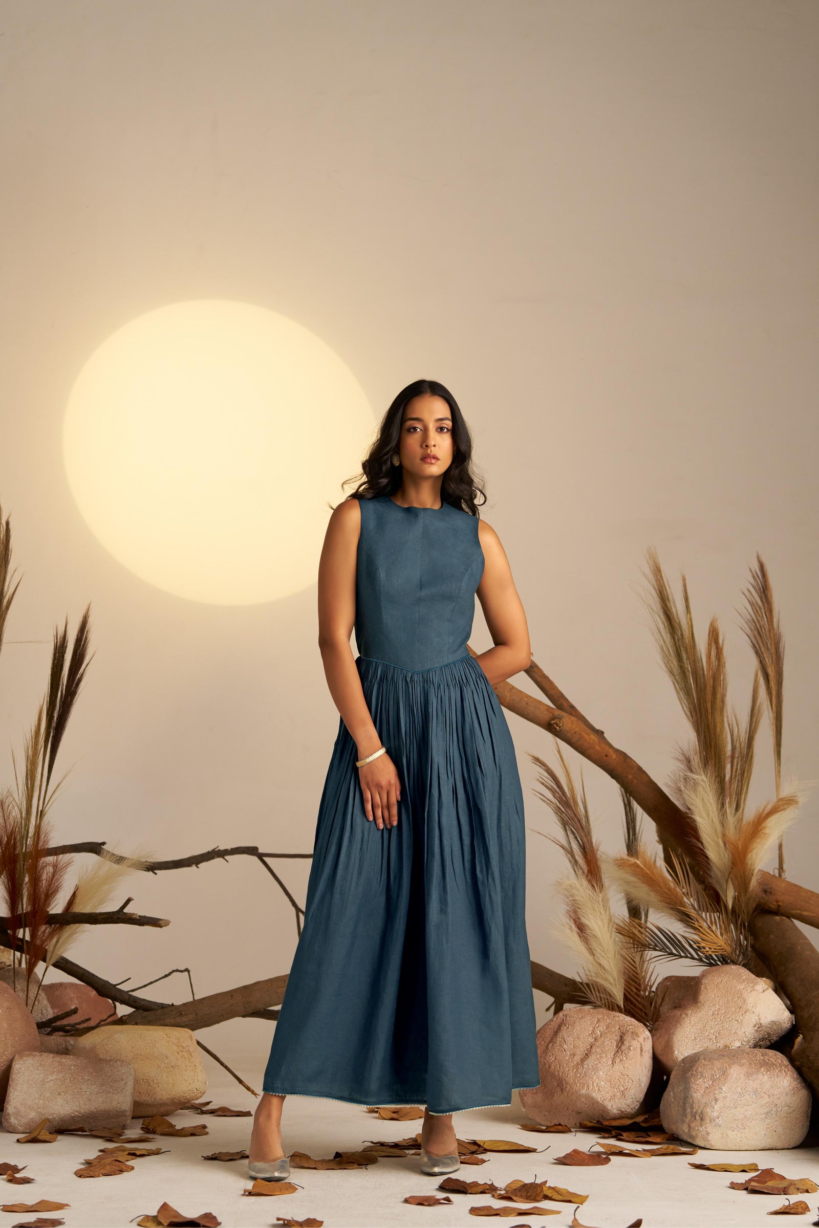 A Stunning Midnight Blue Pleated Dress, Cinched At The Waist To Create A Flattering, Feminine Silhouette