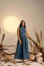 A Stunning Midnight Blue Pleated Dress, Cinched At The Waist To Create A Flattering, Feminine Silhouette
