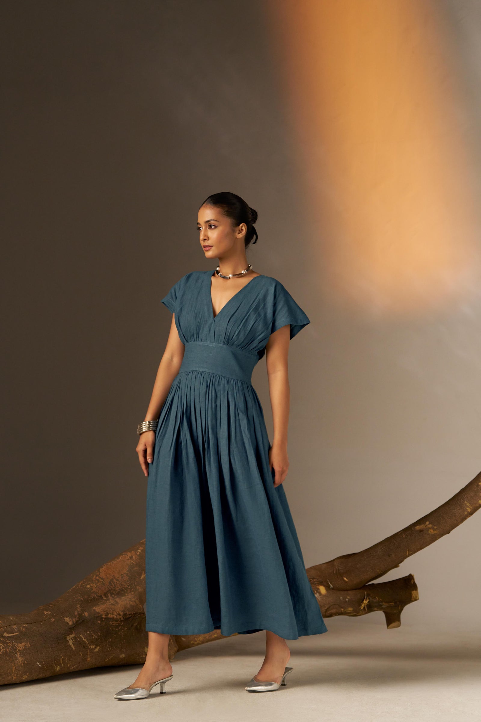 An Elegant Dress In Rich Midnight Blue, Featuring A Defined Waistline And Soft Cap Sleeves For A Feminine, Tailored Look