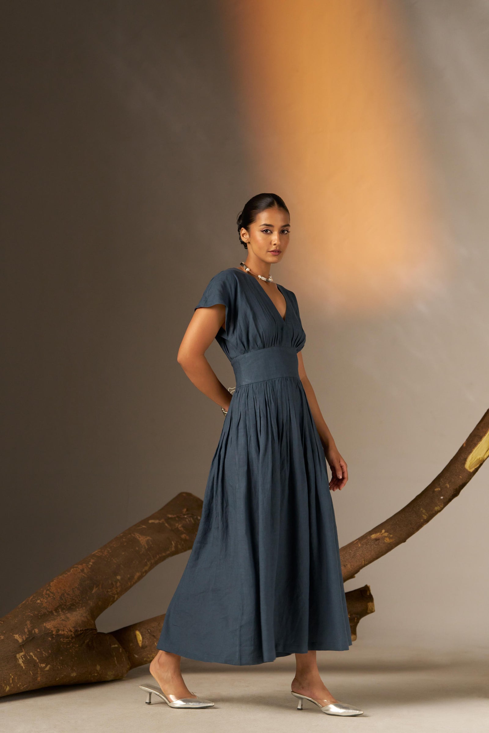 An Elegant Dress In Rich Midnight Blue, Featuring A Defined Waistline And Soft Cap Sleeves For A Feminine, Tailored Look