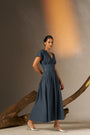 An Elegant Dress In Rich Midnight Blue, Featuring A Defined Waistline And Soft Cap Sleeves For A Feminine, Tailored Look