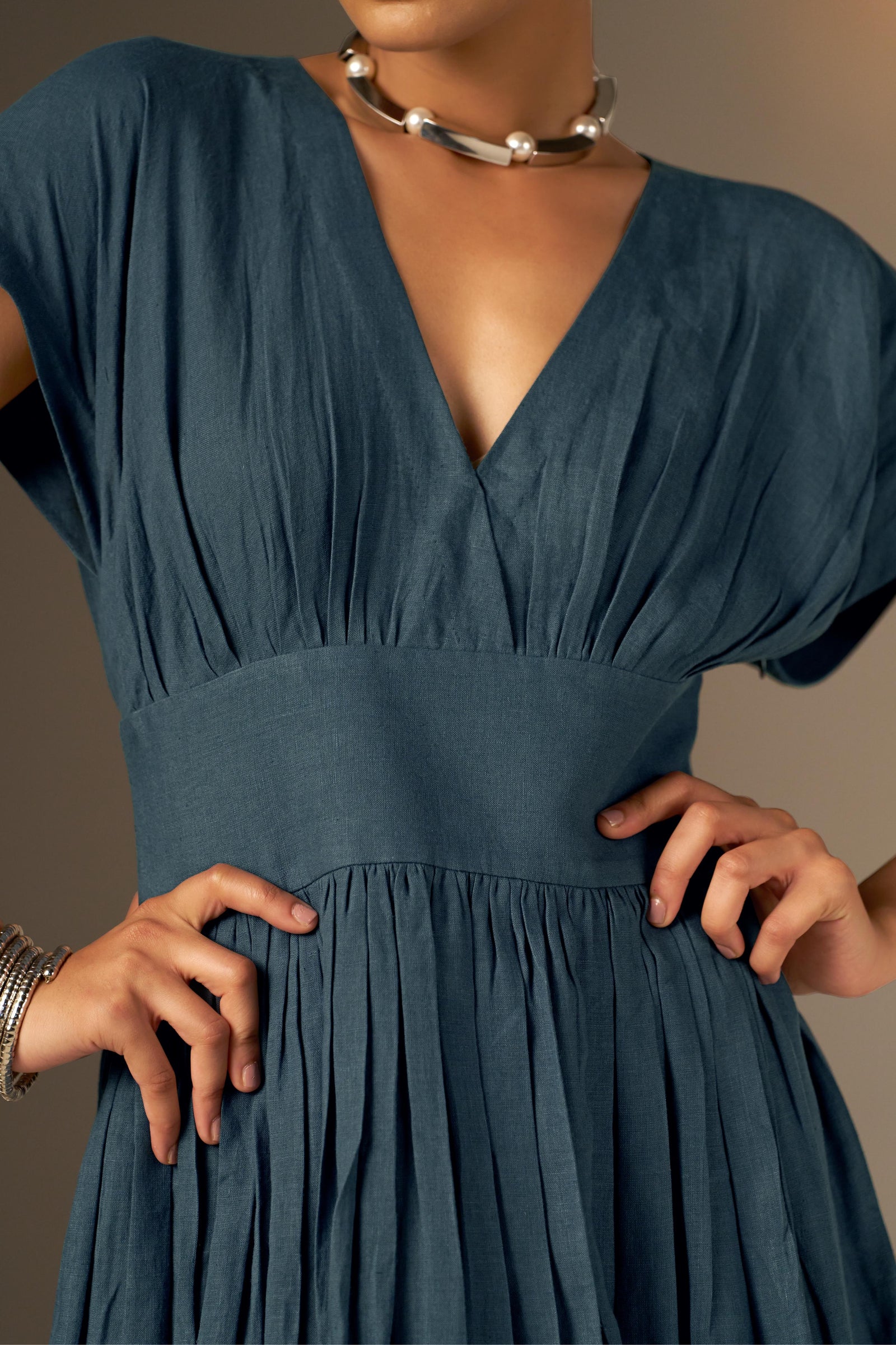 An Elegant Dress In Rich Midnight Blue, Featuring A Defined Waistline And Soft Cap Sleeves For A Feminine, Tailored Look