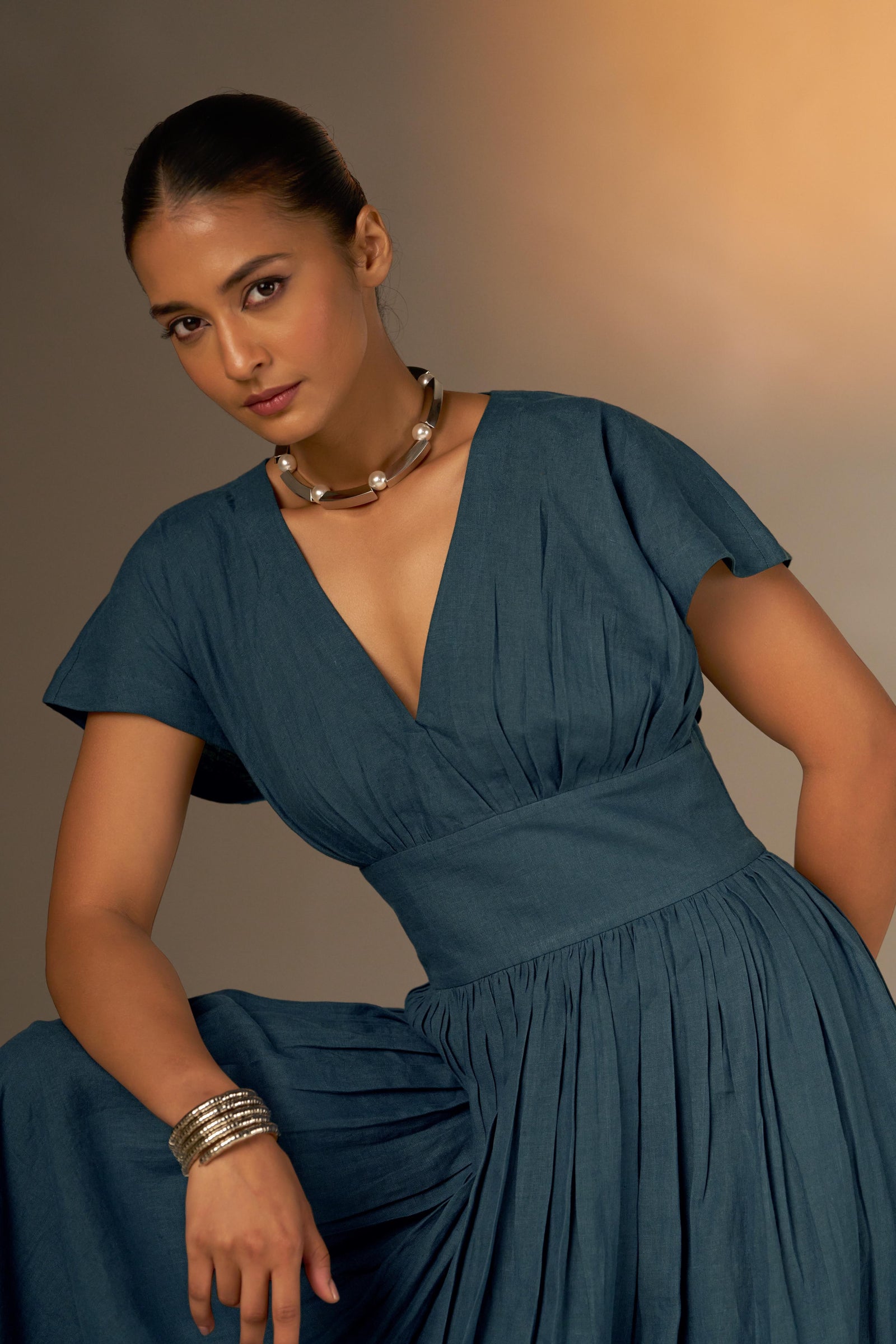 An Elegant Dress In Rich Midnight Blue, Featuring A Defined Waistline And Soft Cap Sleeves For A Feminine, Tailored Look