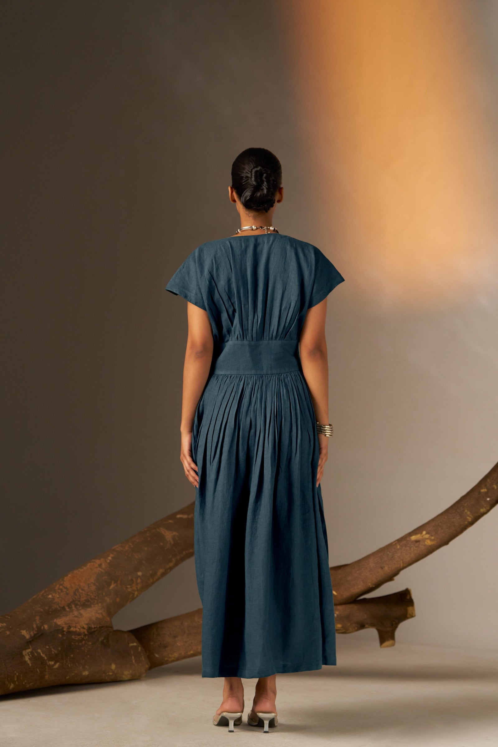An Elegant Dress In Rich Midnight Blue, Featuring A Defined Waistline And Soft Cap Sleeves For A Feminine, Tailored Look