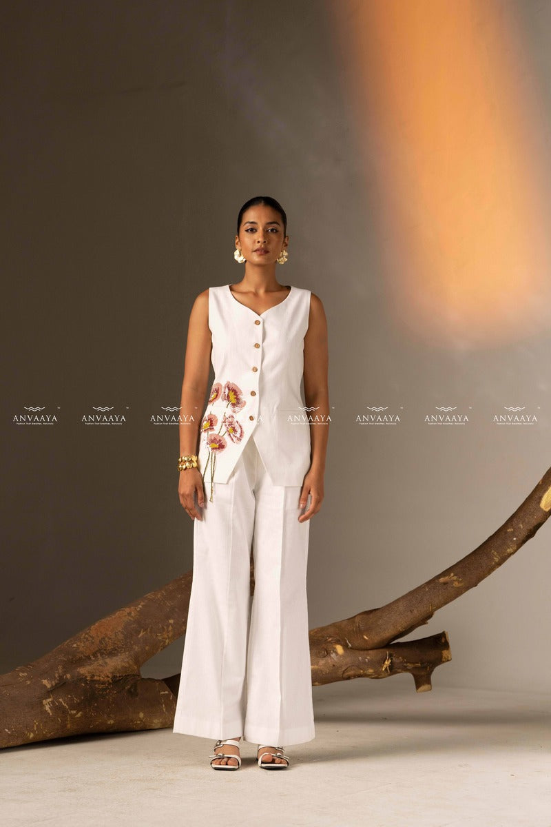 An Elegant White Sleeveless Long Vest Adorned With Delicate Floral Embellishments
