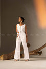 An Elegant White Sleeveless Long Vest Adorned With Delicate Floral Embellishments