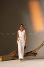 An Elegant White Sleeveless Long Vest Adorned With Delicate Floral Embellishments