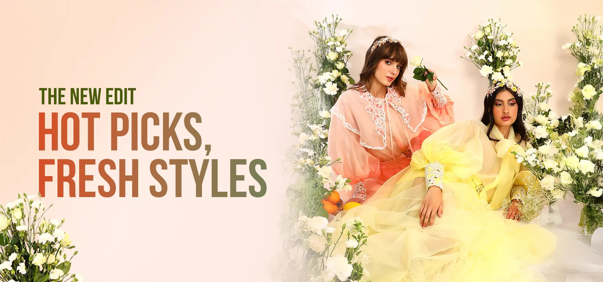 Two women in colorful outfits sitting among flowers with text 'The New Edit Hot Picks, Fresh Styles' on a beige background.